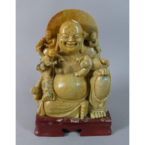 17 - A Carved Soapstone Figure of Seated Smiling Buddha with Four Attendants, 24cm High