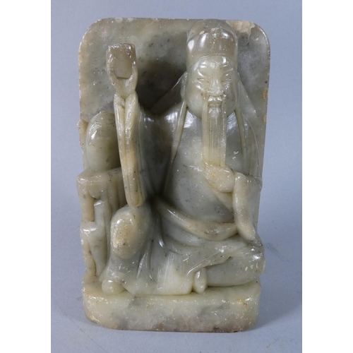 19 - A Carved Soapstone Study of Seated Immortal Raising Cup, 17.5cm High