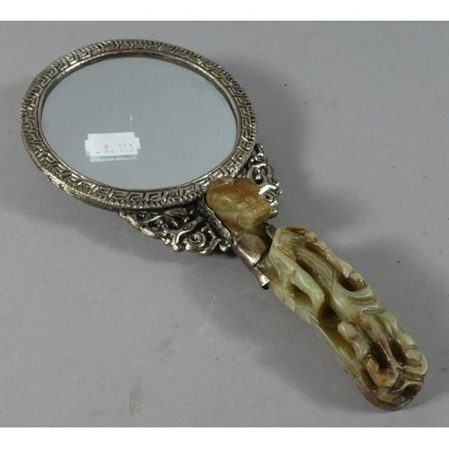 20 - A Reproduction Chinese Hand Mirror with Faux Jade Handle and Back Decorated with Dragons Chasing Fla... 