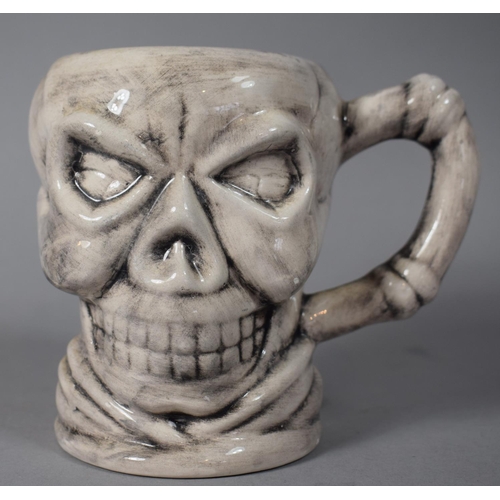 252 - A Novelty Mug in the Form of a Skull, 12cm High