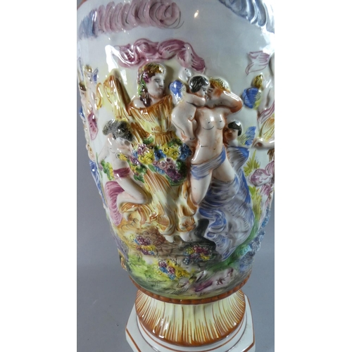 261 - A Large Naples Capodimonte Vase Decorated in Relief Bacchus Scene, 54cm high