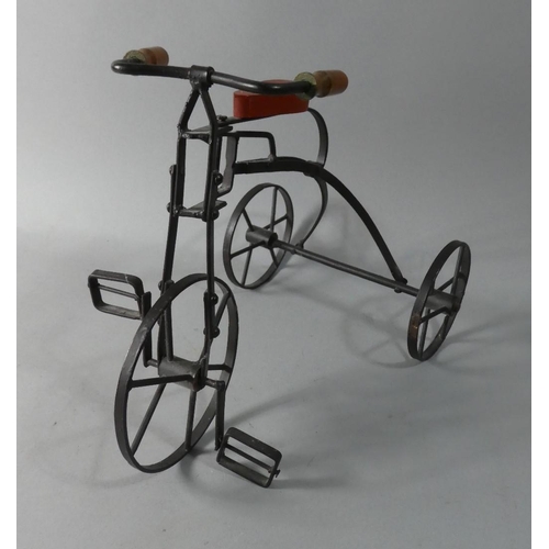 63 - A Reproduction Iron Dolls Tricycle, 24cm High