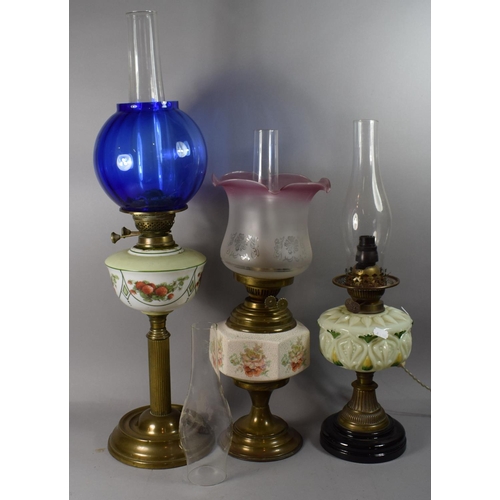 65 - A Collection of Three Oil Lamps, One Converted to Electricity