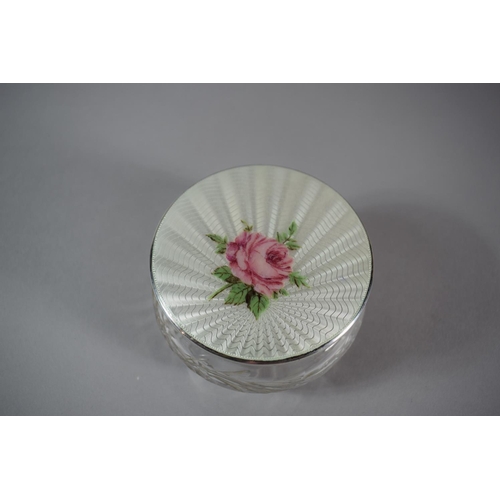 201 - A Glass Dressing Table Powder Pot with Enamelled Silver Lid Decorated with a Rose, 9.5cms Diameter, ... 