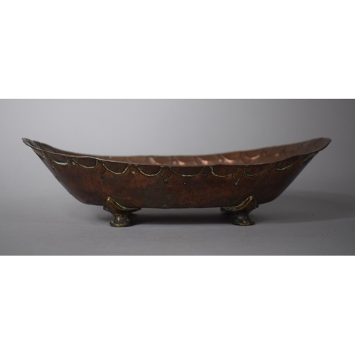 96 - An Arts and Crafts Copper Oval Shallow Boat Dish with Hand Beaten Decoration 27cms Wide Together wit... 
