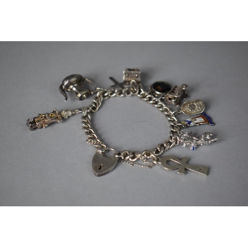 214 - A Silver Charm Bracelet with Ten Charms, 42.8gms