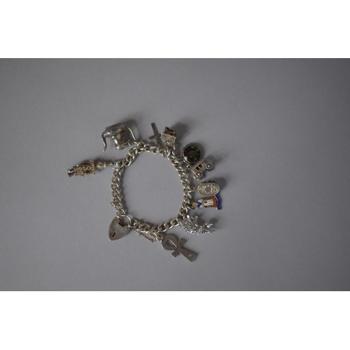 214 - A Silver Charm Bracelet with Ten Charms, 42.8gms