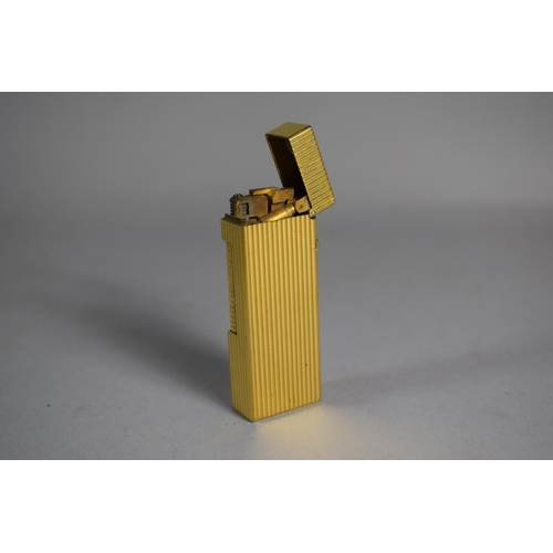 219 - A Dunhill Gold Plated Lighter with Ribbed Body