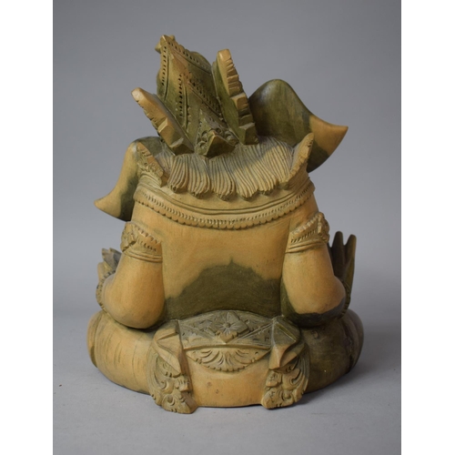 112 - A Carved Wooden Study of Seated Ganesha, 23cm high