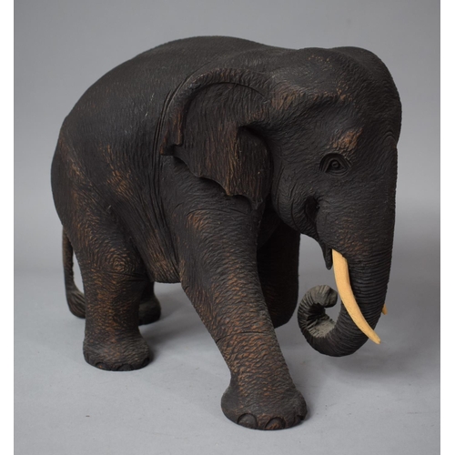 77 - A Carved Wooden Elephant, 22cm High