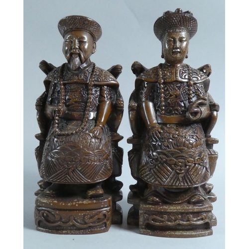 25 - A Pair of Chinese Resin Figures Depicting Seated Dignitaries, Husband and Wife, 20cm high