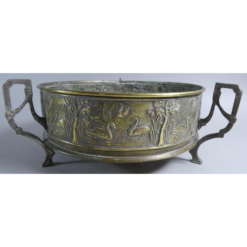 71 - A Circular Brass Three Handled Bowl Decorated in Relief with Swans, 25cm Diameter