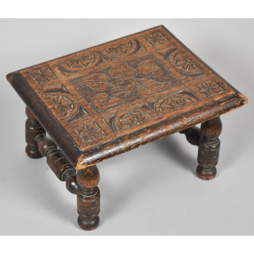 110 - An Edwardian Carved Oak Rectangular Topped Stool on Turned Supports, 31cm wide