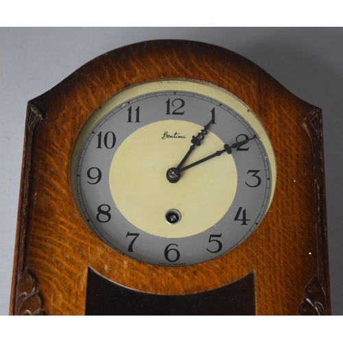 146 - An Edwardian Oak Wall Clock by Bentima, 32cm high