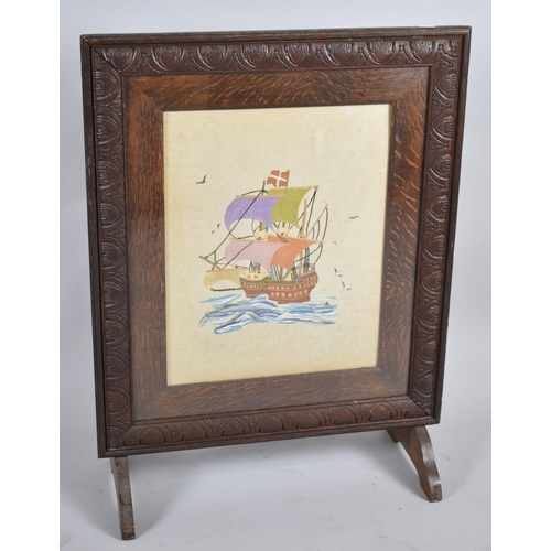 69 - An Edwardian Oak Framed Silk Embroidered Fire Screen Depicting Santa Maria, 59cm wide
