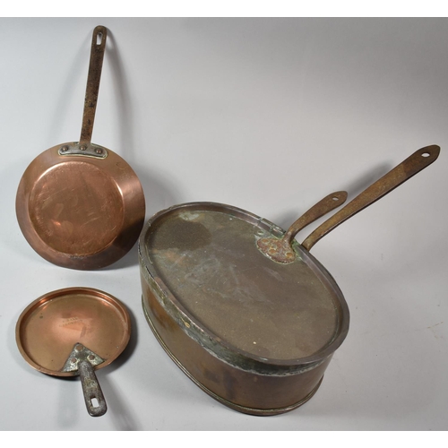 76 - A Lidded Oval Copper Saucepan with Iron Handles, Together with Two Copper Skillets, One Inscribed H ... 