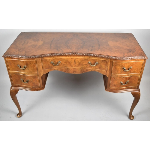 121 - A Mid 20th Century Burr walnut Serpentine Front Kneehole Writing Desk with Centre Drawer Flanked by ... 