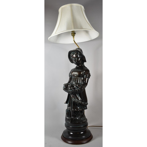 141 - A Glazed Ceramic Figural Table Lamp in the Form of Girl with Basket, Complete with Shade, 104cm high... 