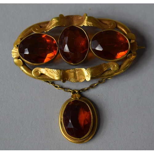 404 - An Early Victorian Pinchbeck and Amber Glass Brooch