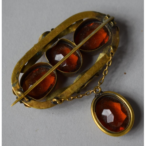 404 - An Early Victorian Pinchbeck and Amber Glass Brooch