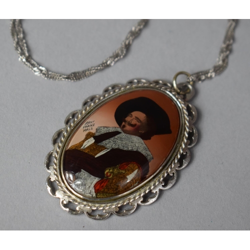 411 - A Silver Pendant and Chain with Enamelled Laughing Cavalier Decoration, 4.5cm high