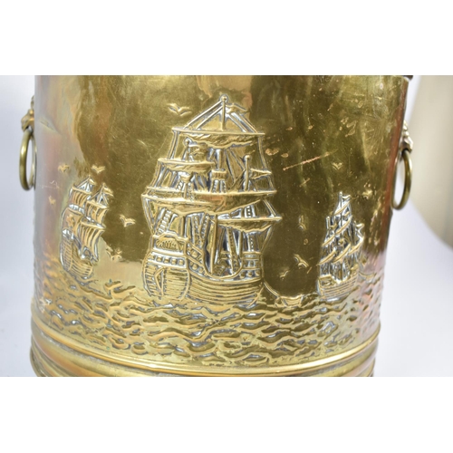 75 - A Mid 20th Century Pressed Brass Coal Bucket with Three Claw Feet and Decorated with Tall Ships, 42c... 