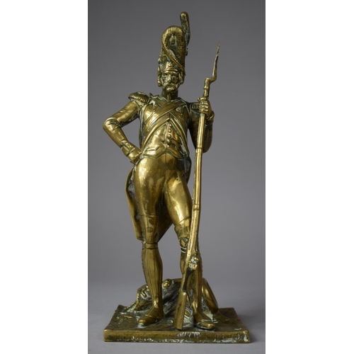 107 - A Moulded Brass Study of a Napoleonic Soldier, 24.5cm high