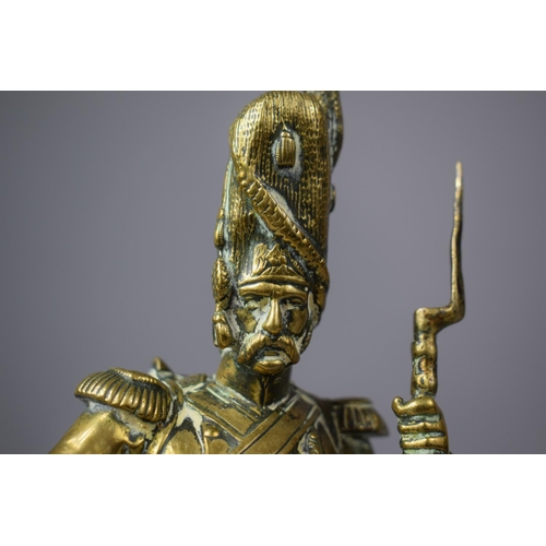 107 - A Moulded Brass Study of a Napoleonic Soldier, 24.5cm high