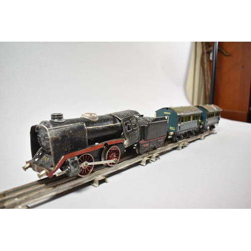 192 - A Collection of Three Rail O Gauge Track, Two Marklin Tinplate Carriages and a Clockwork Locomotive ... 