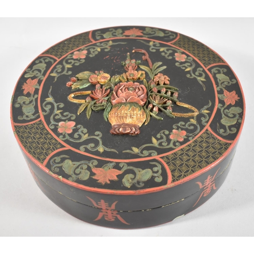 90 - A Chinese Lacquered Box with Floral Decoration in Relief to Lid, 26cm Diameter