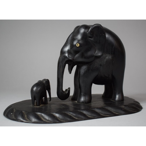 92 - A Carved African Ebonised Study of Elephant and Calf on Oval Plinth Base, 23.5cm Long