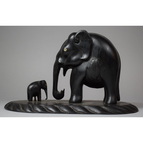 92 - A Carved African Ebonised Study of Elephant and Calf on Oval Plinth Base, 23.5cm Long