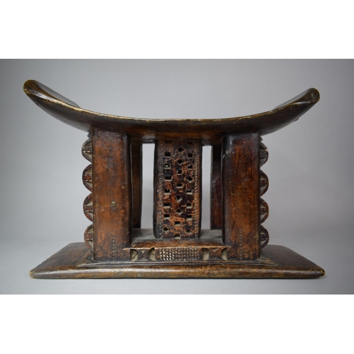 95 - A 19th Century African Ashanti Carved Wooden Stool with Pierced Decoration, 42cm wide