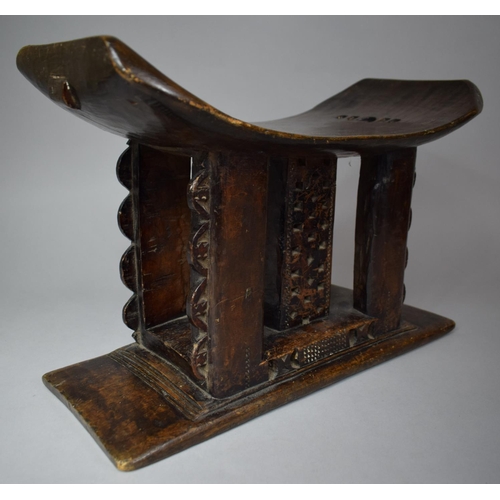 95 - A 19th Century African Ashanti Carved Wooden Stool with Pierced Decoration, 42cm wide