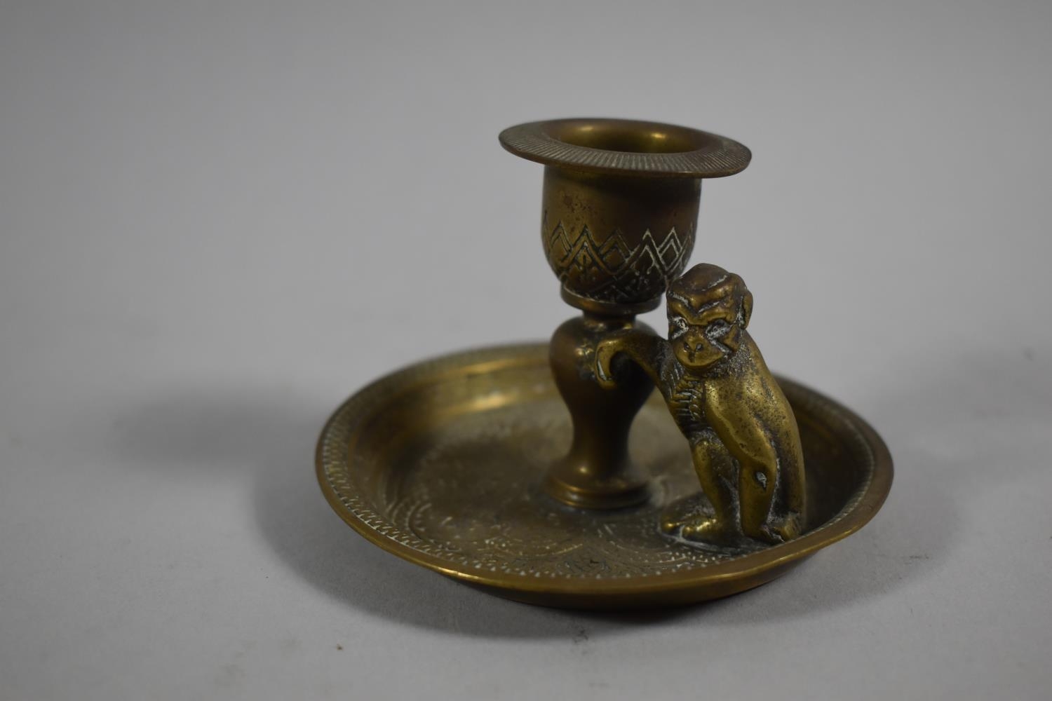 A Small Brass Candlestick with Monkey Mount by Kinco, England, 9cm Diameter