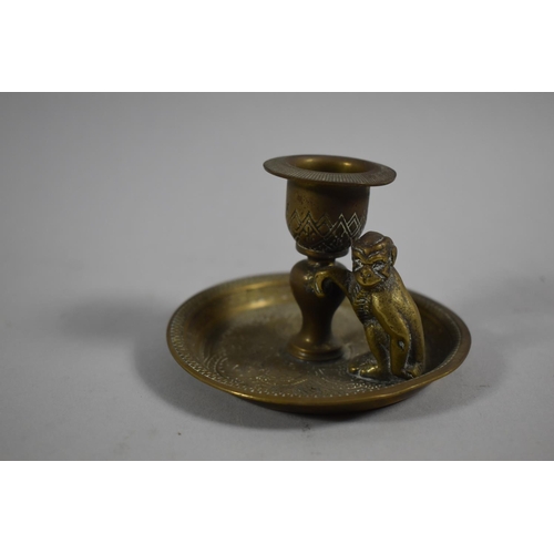 A Small Brass Candlestick with Monkey Mount by Kinco, England, 9cm Diameter