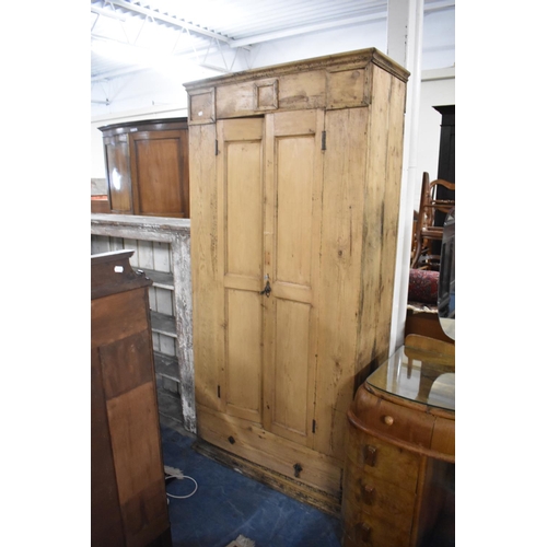 531 - A Stripped Pine Hanging Wardrobe with Base Drawer, 95cm wide