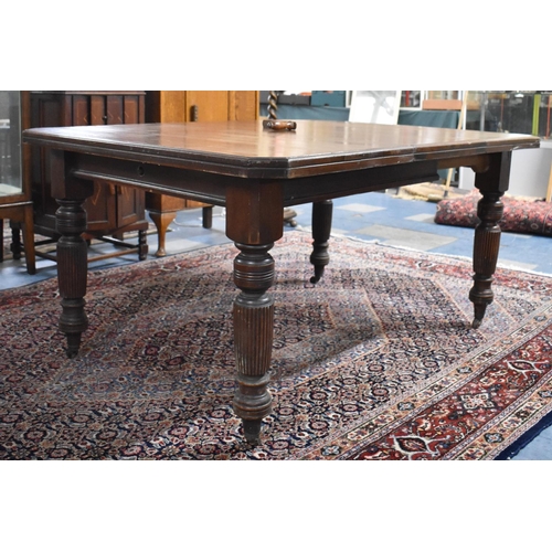 540 - An Edwardian Mahogany Wind-out Dining Table with One Extra Leaf