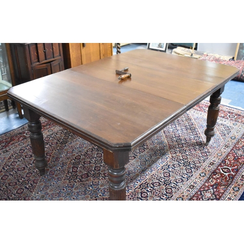 540 - An Edwardian Mahogany Wind-out Dining Table with One Extra Leaf