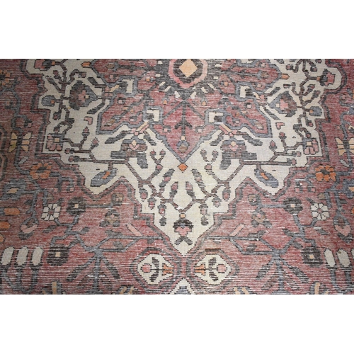 556 - A Rectangular Patterned Woollen Rug, 317x209cm