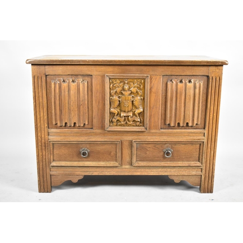 560 - A Mid 20th Century Panelled Oak Lift Top Linenfold Coffer with Armorial Panel and Two Base Drawers