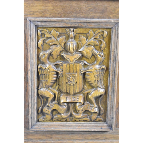 560 - A Mid 20th Century Panelled Oak Lift Top Linenfold Coffer with Armorial Panel and Two Base Drawers