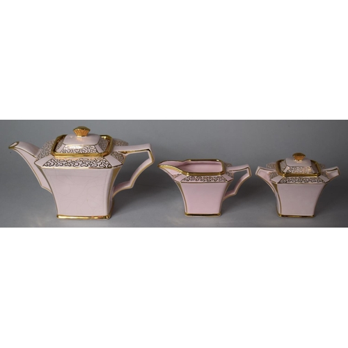 322 - A Pink and Gilt Sadlers Three Piece Teaset comprising Teapot, Milk and Lidded Sugar