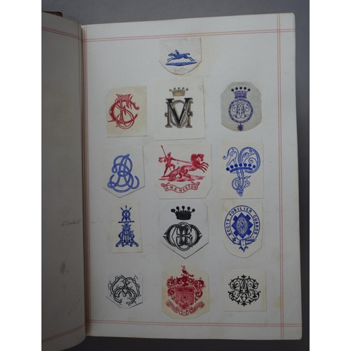 350 - A Leather Bound and Tooled Leather Album Containing Affixed and Loose Printed Crests and Monograms