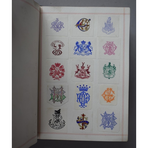 350 - A Leather Bound and Tooled Leather Album Containing Affixed and Loose Printed Crests and Monograms