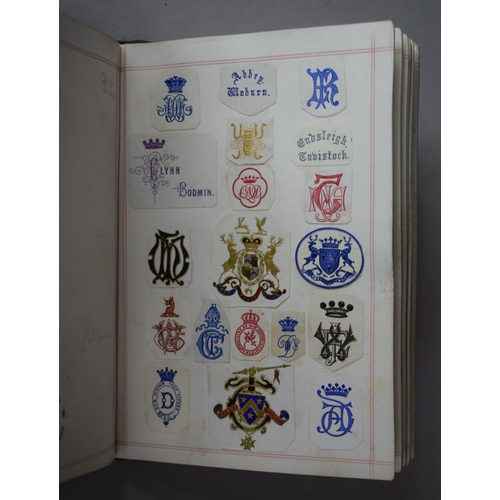 350 - A Leather Bound and Tooled Leather Album Containing Affixed and Loose Printed Crests and Monograms