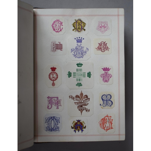 350 - A Leather Bound and Tooled Leather Album Containing Affixed and Loose Printed Crests and Monograms