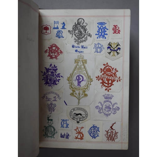 350 - A Leather Bound and Tooled Leather Album Containing Affixed and Loose Printed Crests and Monograms