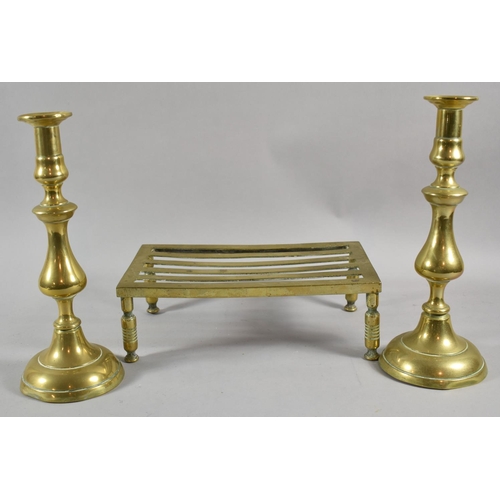 66 - A Brass Rectangular Trivet and Pair of 19th Century Brass Candlesticks, 30cm high