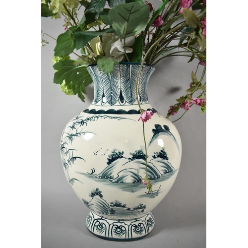 161 - A Large Blue and White Vase Containing Artificial Flowers, 40cm high